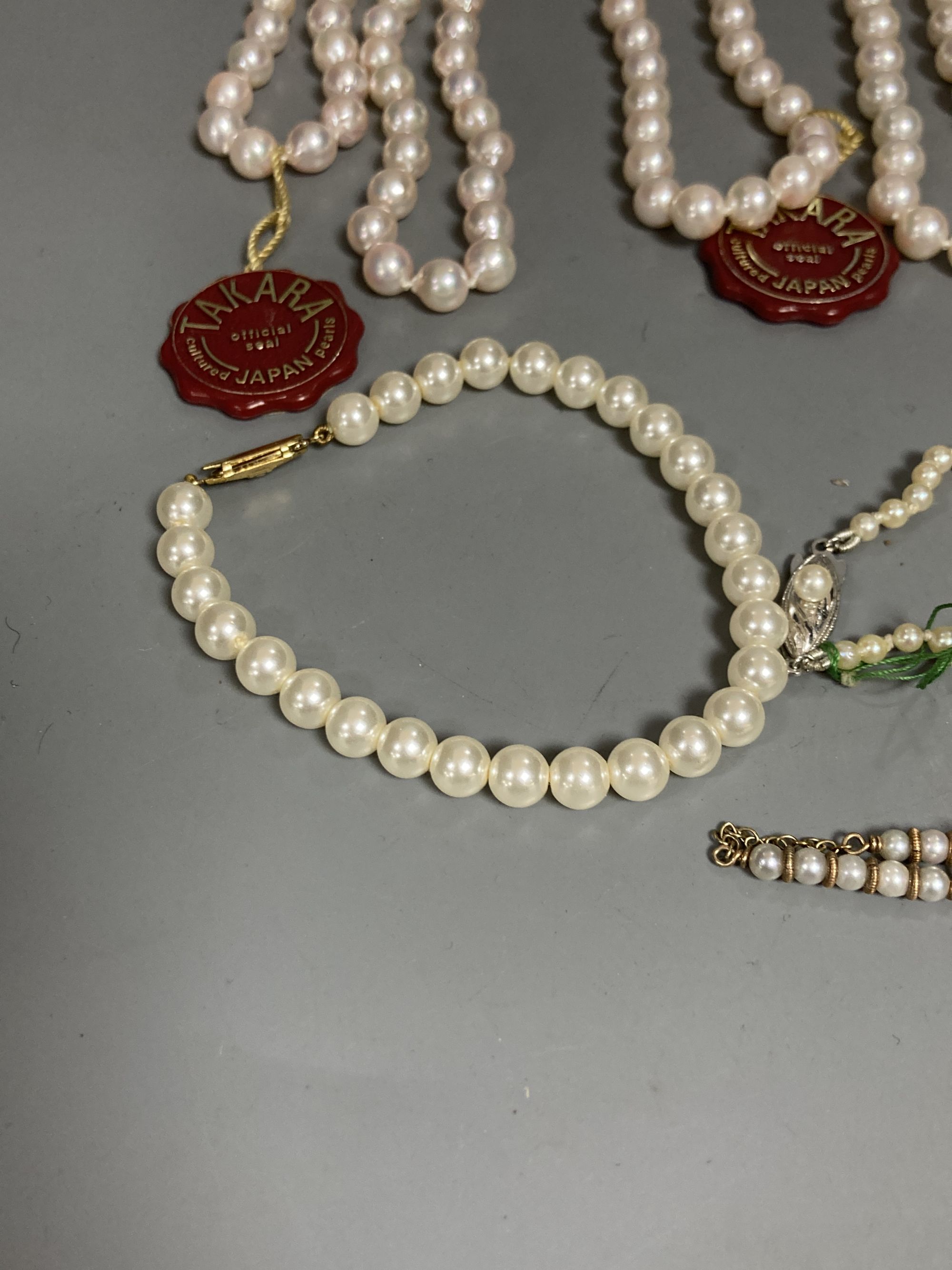 Four assorted modern single strand cultured pearl necklaces, longest 83cm, one other 9ct and cultured pearl necklace(a.f.) and two simulated pearl necklaces.